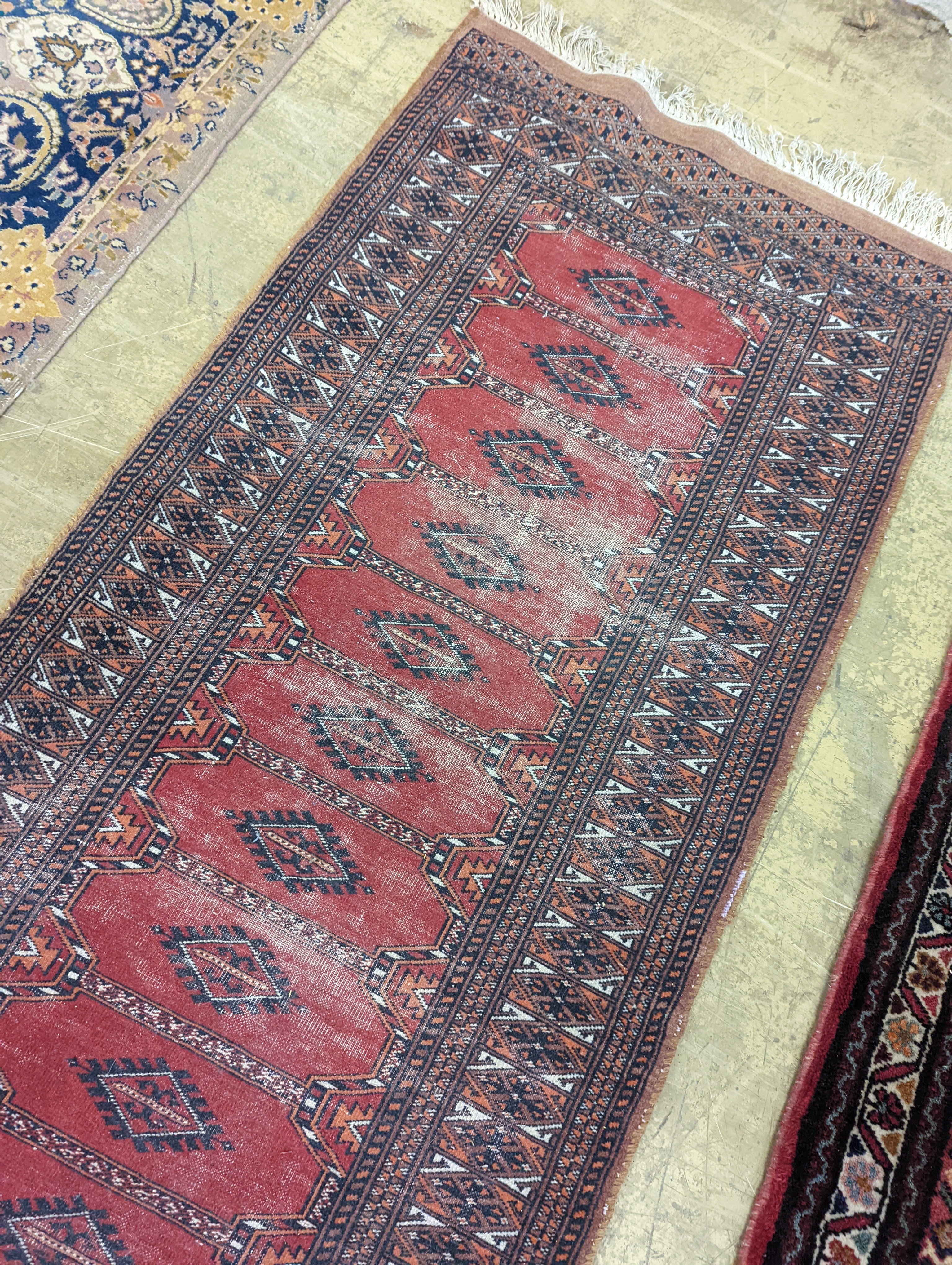 A North West Persian red ground runner and a Bokhara runner, larger approx. 290 x 78cm